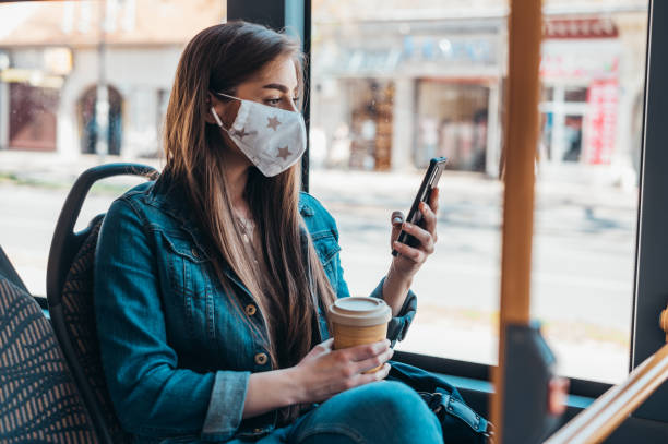 istock Woman wearing protective mask while riding a bus 1320045220