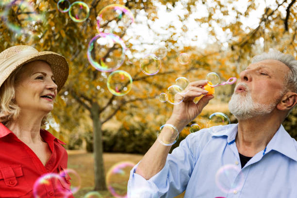istock Senior couple blowing soap bubbles 1320050798