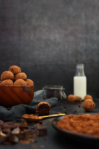 Stock photo showing a display of homemade, individual, luxury chocolate truffles with a ganache centre and coated in a dusting of cocoa powder. These luxury chocolate balls are ideal as a birthday present.