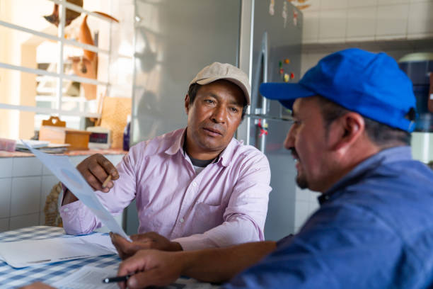 istock Farmers doing business together and looking at documents 1320059455
