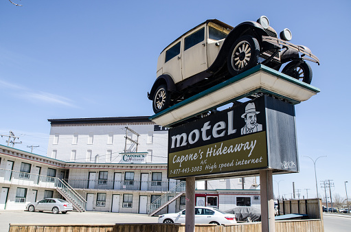 Sign of Capone's Hideaway Motel in Moose Jaw during day of springtime