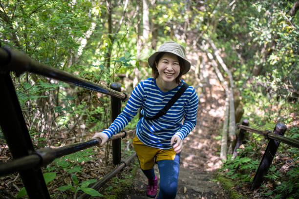 istock Young woman climbing moutain 1320064630