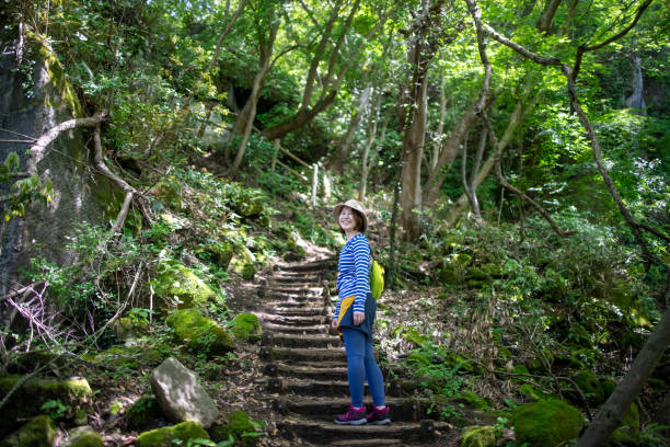 istock Young woman looking over shoulder during climbing mountain 1320064635