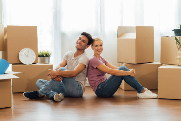istock Couple packing stuffs in cardboard box 1320066208