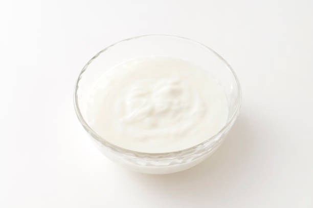 istock Yogurt in a glass bowl on white background 1320072568