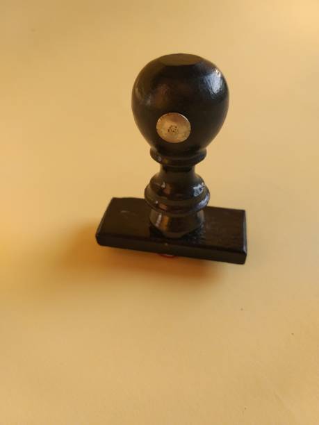 istock Black wooden stamp handle on yellow background 1320074550