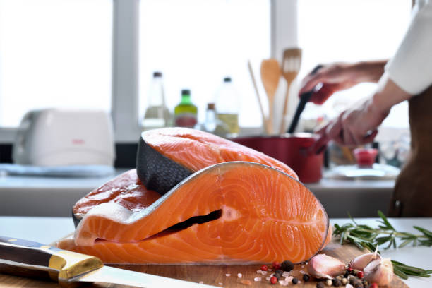 istock Fresh raw salmon fillet steaks with ingredient on a cutting board in the kitchen 1320077269