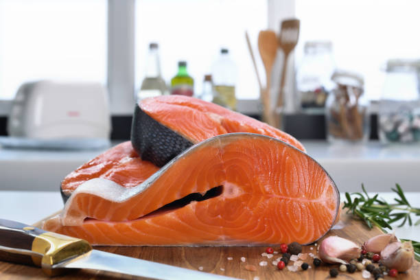 istock Fresh raw salmon fillet steaks with ingredient on a cutting board in the kitchen 1320077278
