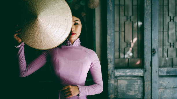 Beautiful vietnamese woman Beautiful vietnamese woman in Ao Dai white-traditional dress of vietnam, Ho Chi Minh city Vietnam ao dai stock pictures, royalty-free photos & images
