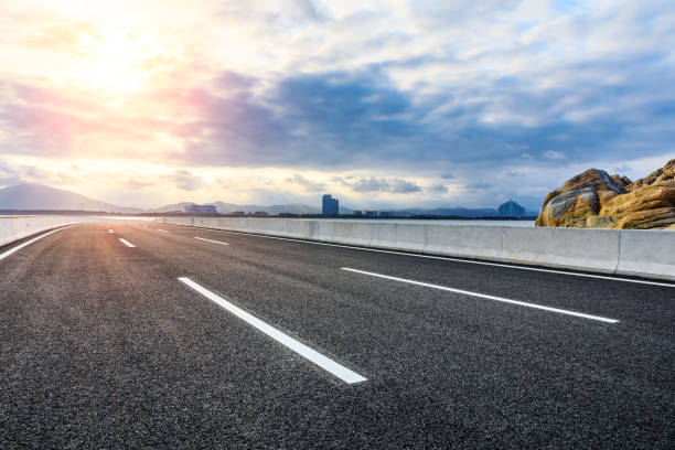 istock Empty asphalt road and city skyline scenery. 1320083873