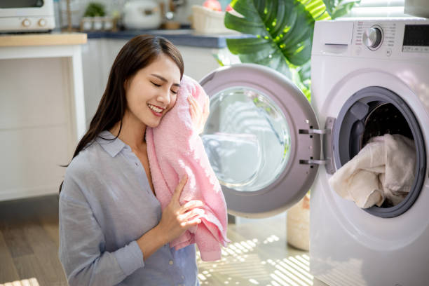 istock woman take clothes from washer 1320085715