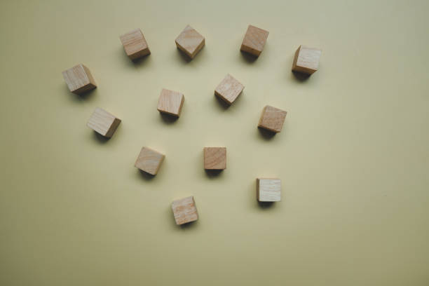 istock Wood block disrupted on a yellow floor background 1320086626
