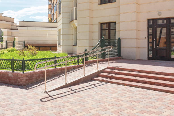 The staircase to the entrance is equipped with stainless steel handrails and a gentle descent and ascent for easy access by wheelchair users. stock photo