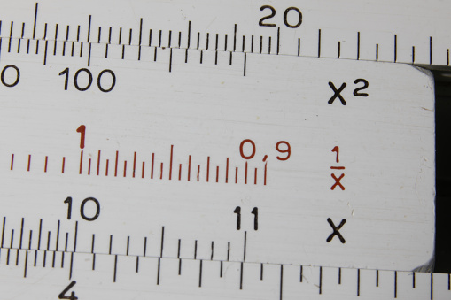 Macro image of old scratched slide rule - an old mathematical tool for calculations from before the era of electronic calculators.