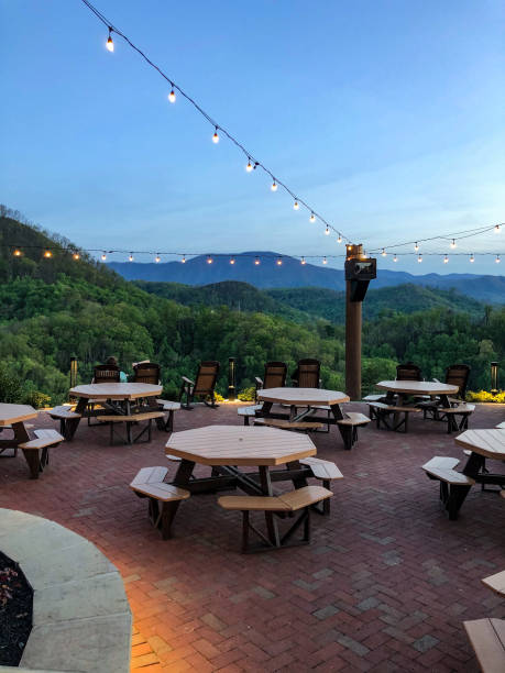 Scenic mountain view from outdoor dining area The Great Smoky Mountains look gorgeous from this outdoor dining area at Anakeesta in Gatlinburg, Tennessee.  There are octagon tables and beautiful lights hanging above. gatlinburg stock pictures, royalty-free photos & images