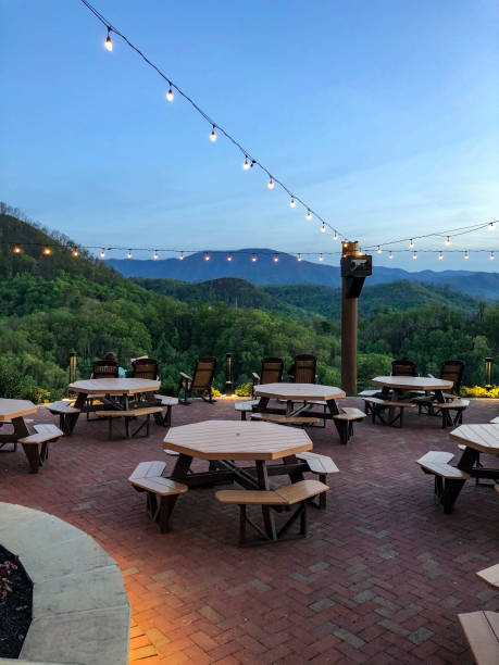 Scenic mountain view from outdoor dining area The Great Smoky Mountains look gorgeous from this outdoor dining area at Anakeesta in Gatlinburg, Tennessee. There are octagon tables and beautiful lights hanging above. gatlinburg stock pictures, royalty-free photos & images