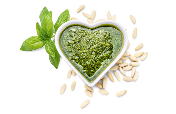 istock Genoese pesto sauce with basil and pine nuts. Top view, isolated on white background. 1320090956