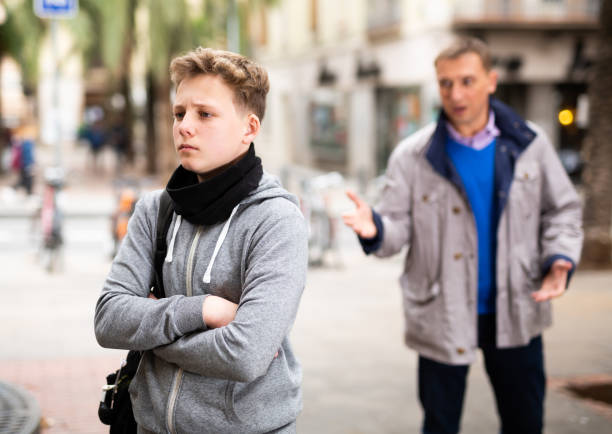 istock Troubled teen boy with man stranger scolding him 1320092020