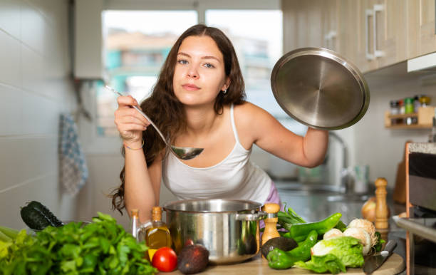 istock Woman holding cooking ladle spoon while cooking soup 1320093011