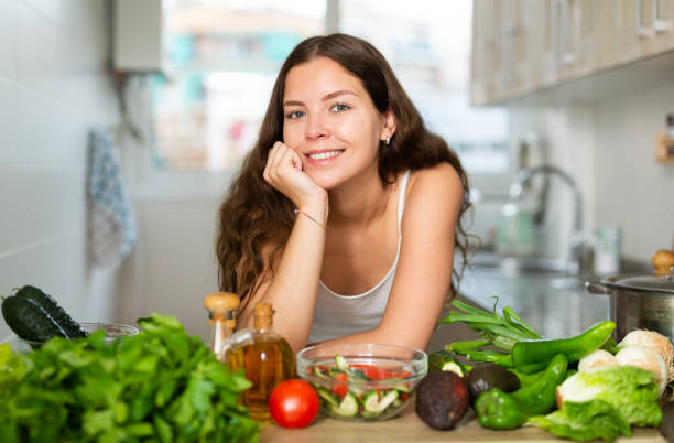 istock Portrait of young woman posing in kitchen 1320093020