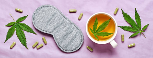 healthy night sleep concept. sleep mask, calming hemp tea and hemp capsules on silk lilac banner - narcotic medicine pill insomnia imagens e fotografias de stock