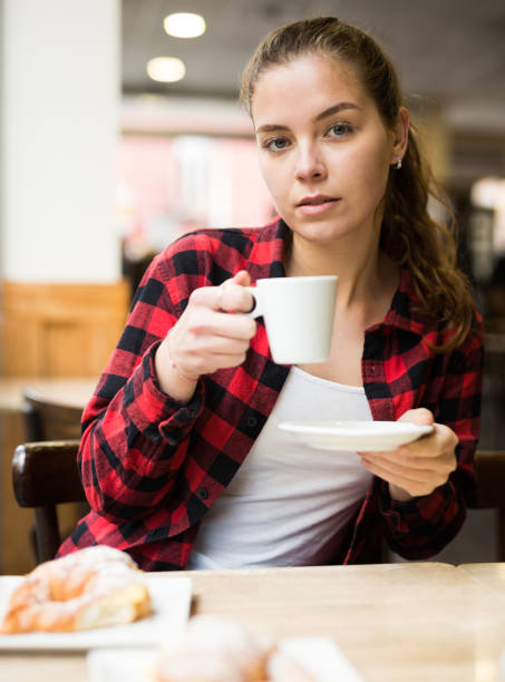 istock Portrait of a young female, drinking coffee from a cup 1320093375