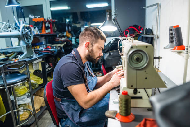 istock Working in repair shop on sewing machine 1320095111