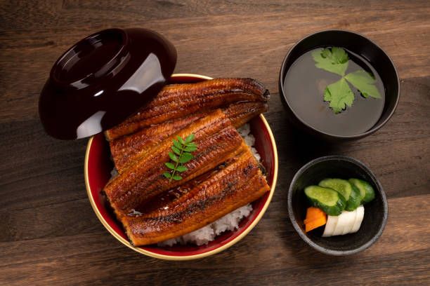 istock Una-juu or eel bowl. Marinated eel over a box of rice. 1320097155