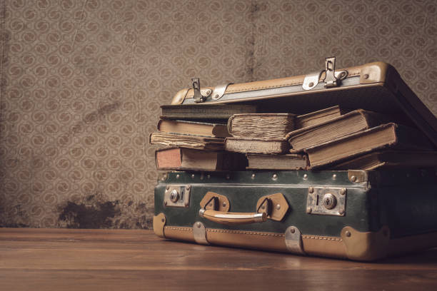 istock Vintage suitcase full of old books 1320097213