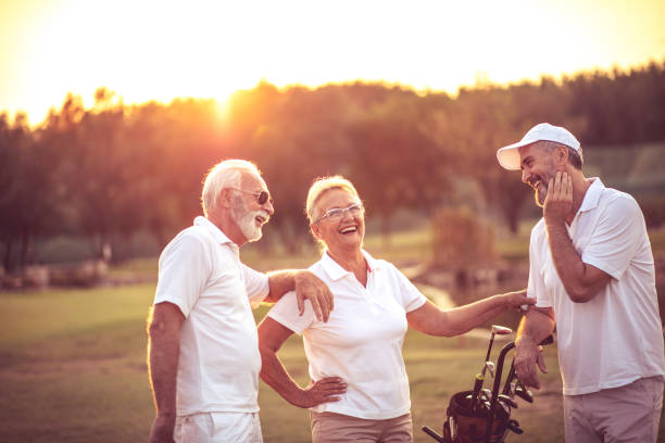 istock Three seniors golfers talking on golf field. 1320100262