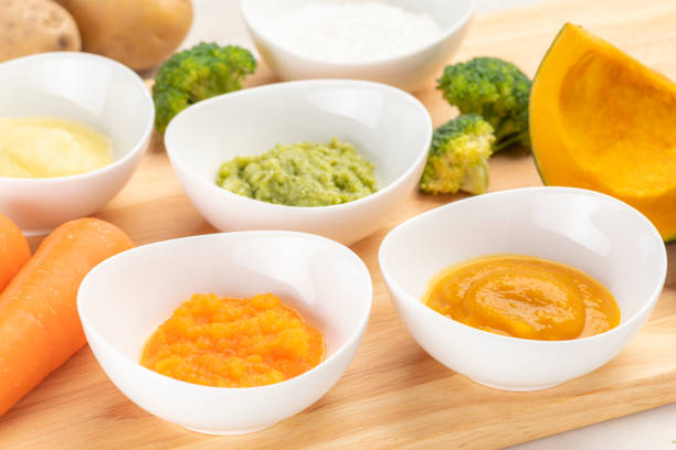 istock Homemade baby food with mashed vegetables 1320101273