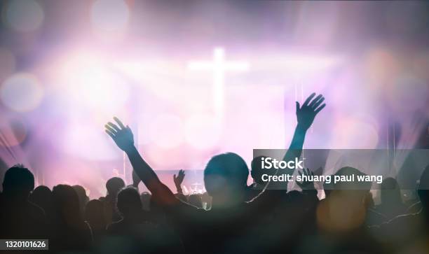 Christians Raising Their Hands In Praise And Worship At Cross Background Stock Photo - Download Image Now