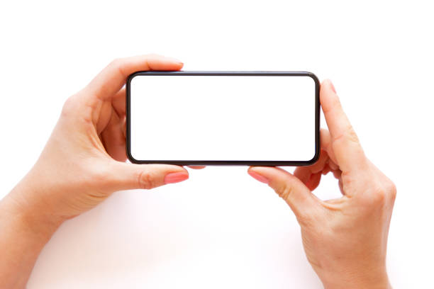 istock Person holding phone horizontally in both hands on white background 1320102751