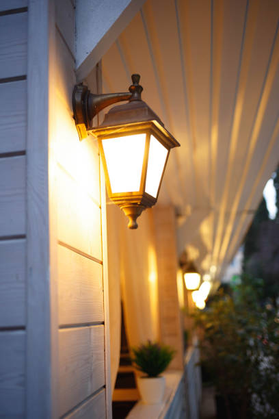 istock street lamp hangs on the wall and shines with warm light 1320104566