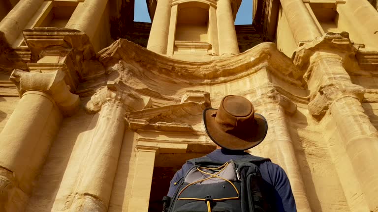 Explorer Viewing Petra Ruins in Awe