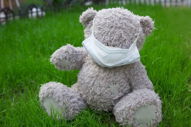 istock mask on a toy bear on grass in backyard 1320107736