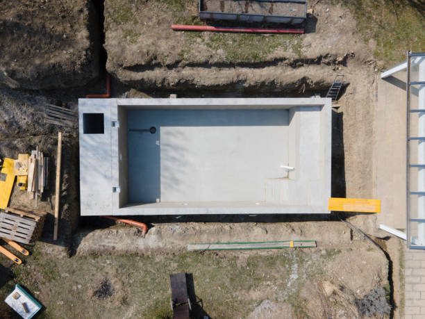 istock Drone shot of pool construction site where the pool is already finished filled, plastered without foil 1320107839