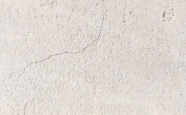 Vector illustration of A fragment of an old wall painted white with visible grammage and cracks - abstract vector illustration background of destroyed concrete surface in old house - porous texture with wrinkles and small recesses - dried soil surface