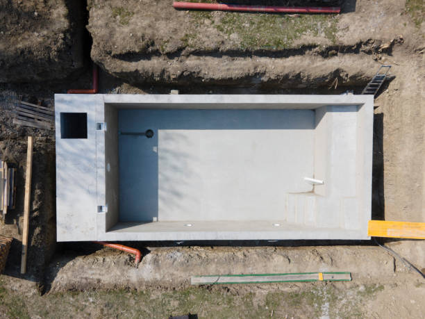 istock Drone shot of pool construction site where the pool is already finished filled, plastered without foil 1320107898