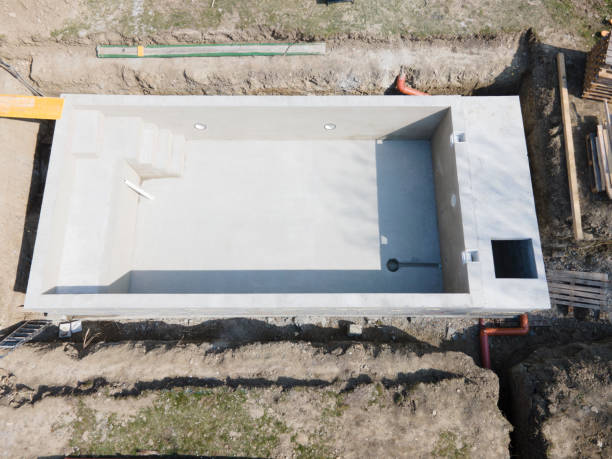 istock Drone shot of pool construction site where the pool is already finished filled, plastered without foil 1320108079