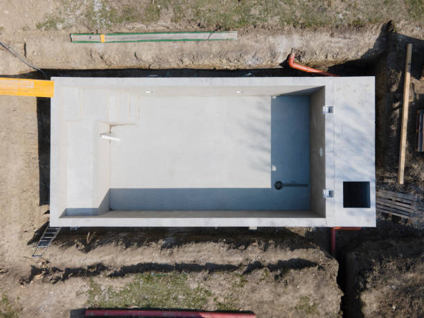 istock Drone shot of pool construction site where the pool is already finished filled, plastered without foil 1320108093
