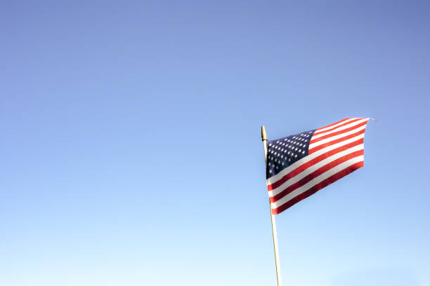 istock Flag on a blue sky background with copy space. American folag, simvon holiday concept. 1320108123