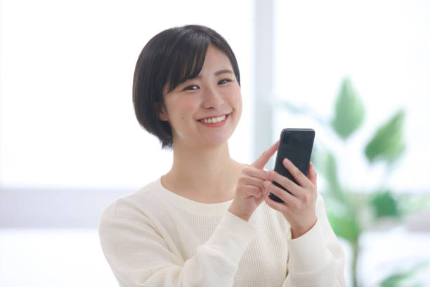 istock Female employee operating a smartphone 1320111371