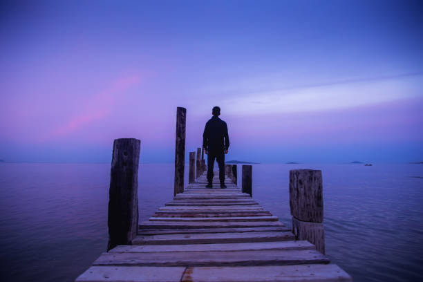 istock Loneliness man standing on wood pedestrian bridge 1320113255