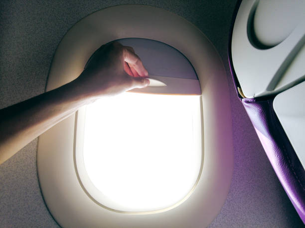 istock Close-up hand open the airplane window 1320113485