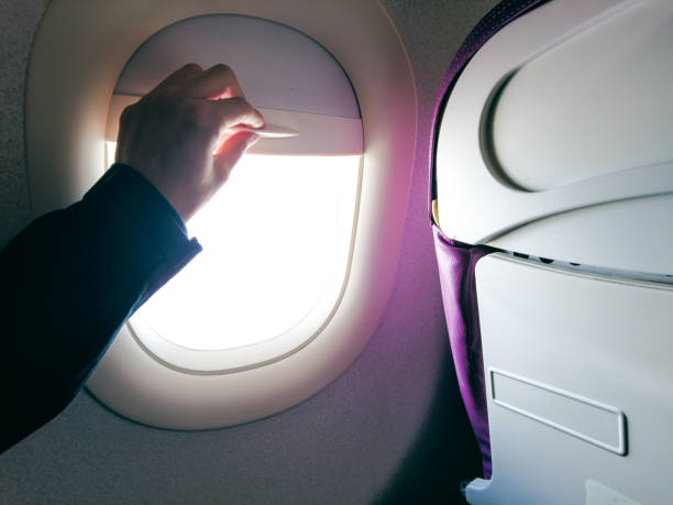 istock Close-up hand open the airplane window 1320113490