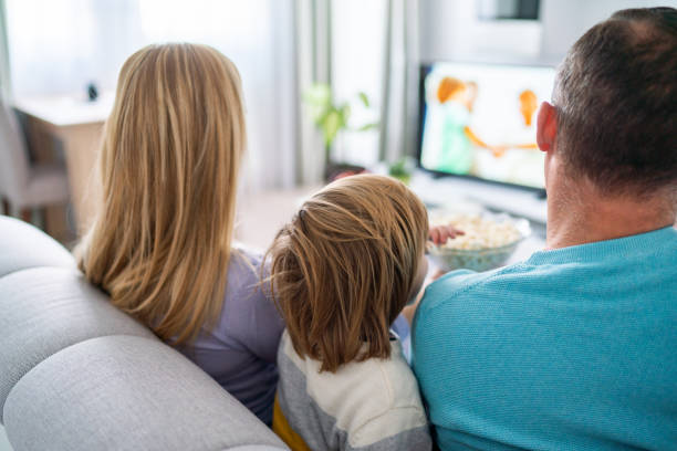 istock Close up family watching tv 1320114276