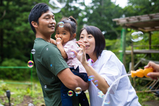 istock Young family playing with bubbles outside 1320114797