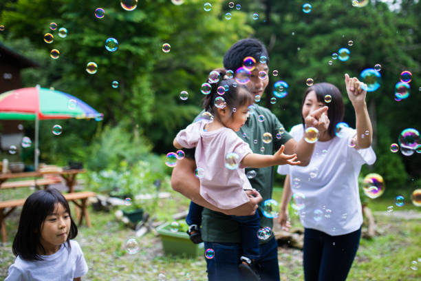 istock Young family playing with bubbles outside 1320114799