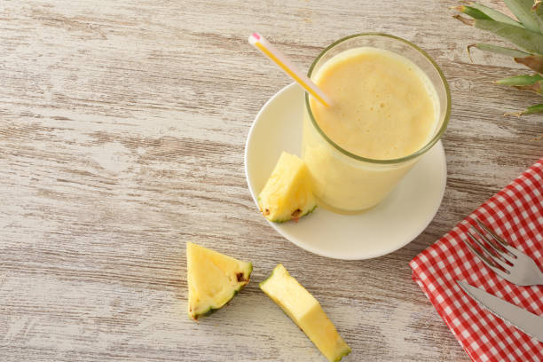 istock Glass with pineapple and milk shake top view 1320117384